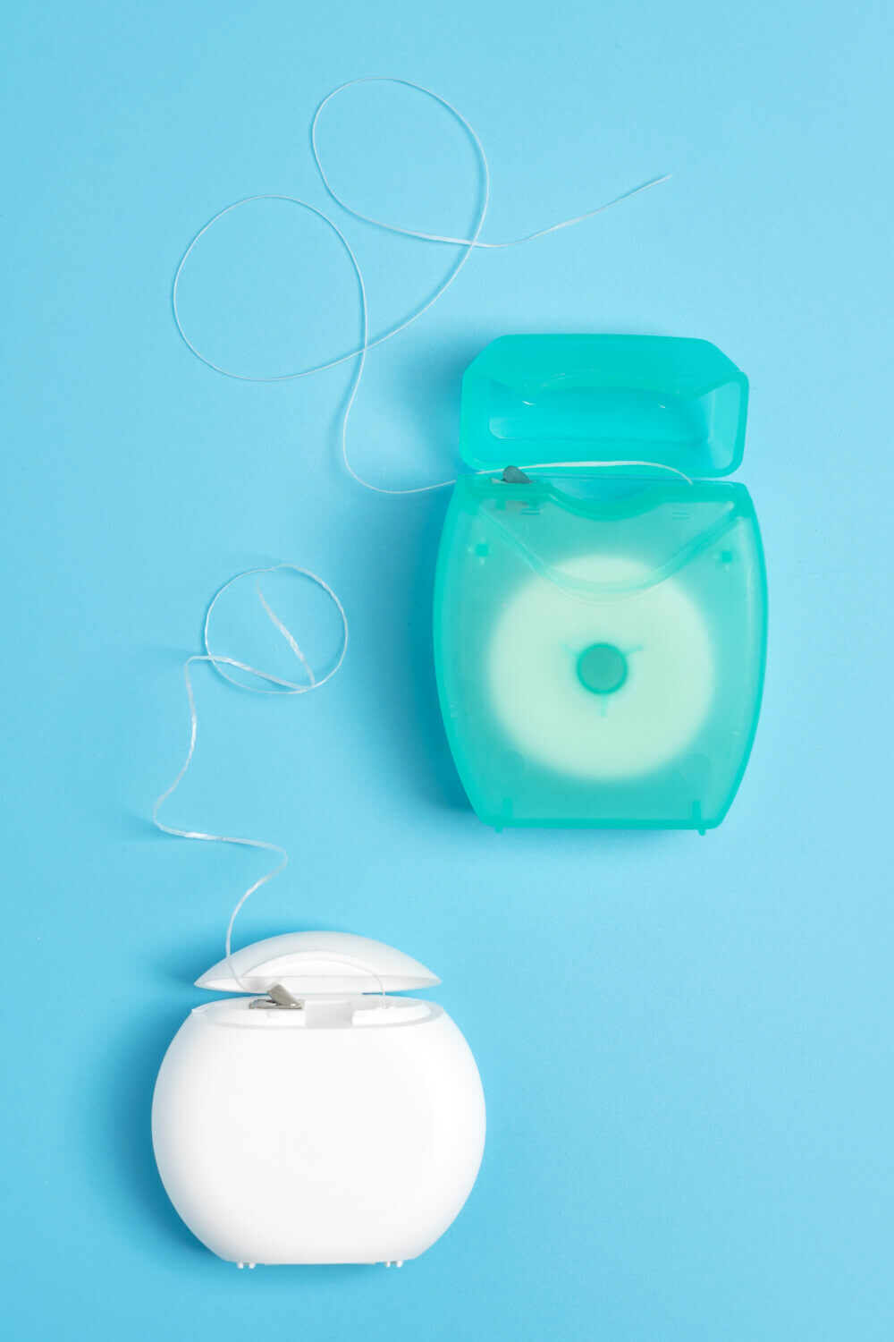cajitas de hilo dental verde y blanca